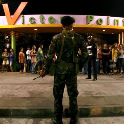 Тайландски войник охранява зоната до автобусна спирка, където избухна бомба