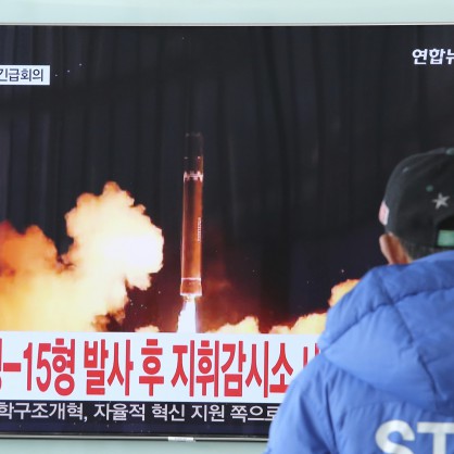 Южнокореец наблюдава на екрана изстрелване на ракета, каквато Северна Корея нарича Хвасонг 15